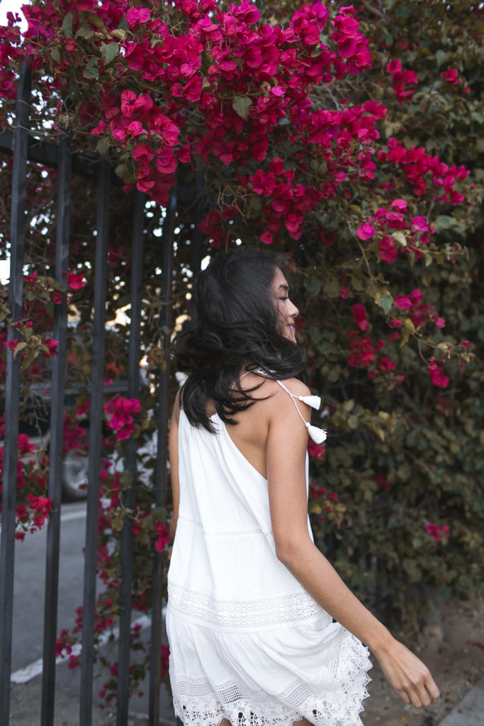 Amy Zhang of the Luxi Look showing the back details of her Urban Outfitters White Dress one of the best Summer Dresses