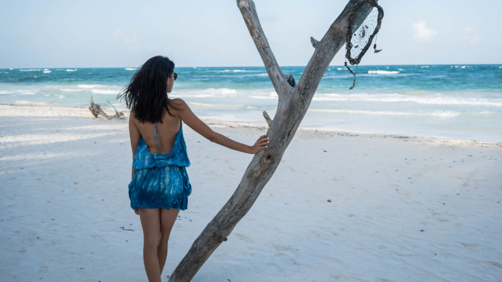 Amy Zhang The Luxi Look blogger showing the back details of her Blue Life Island Halter Dress for her Tulum Travel Diary