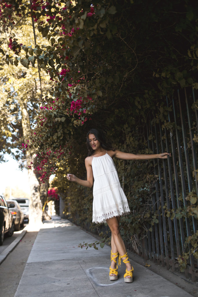 Amy Zhang of the Luxi Look wearing a little white dress one of the best Summer Dresses