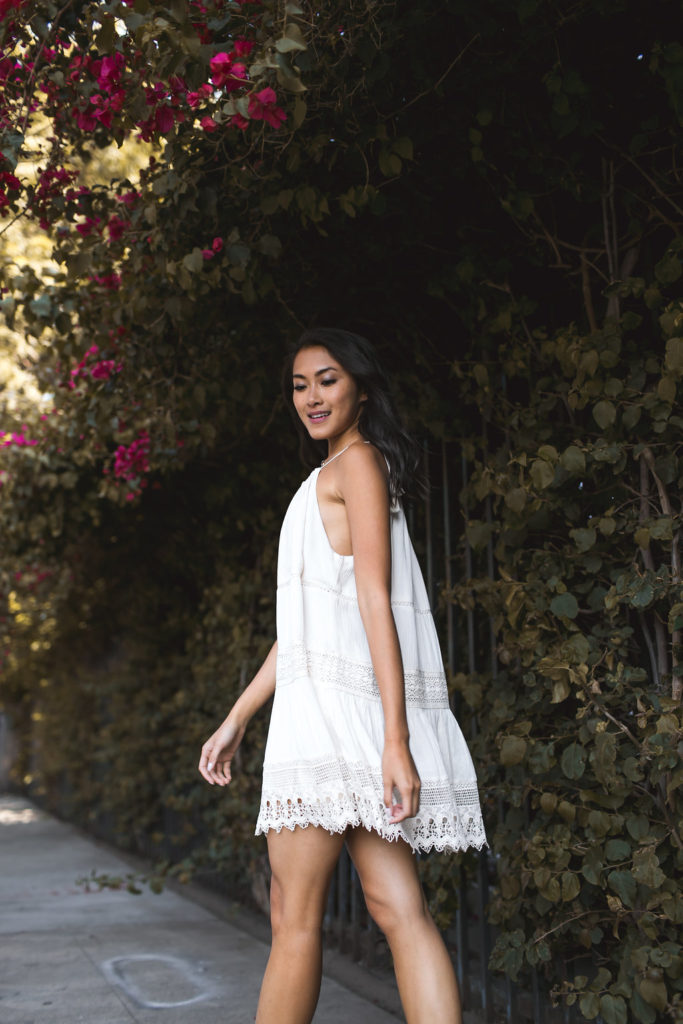 Amy Zhang of the Luxi Look showing the side details of her Urban Outfitters White Dress one of the best Summer Dresses