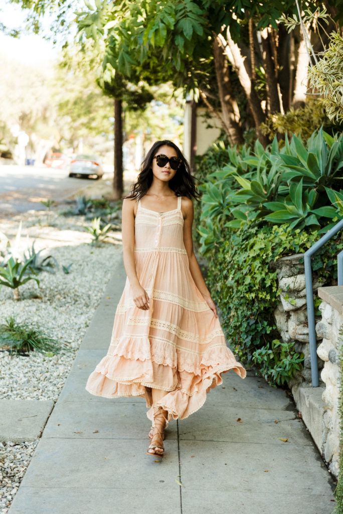 woman in a flowy dress and sunglasses 