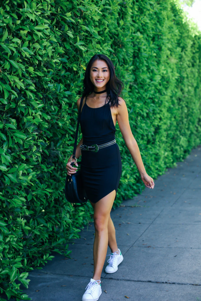 woman wearing a black dress and walking 