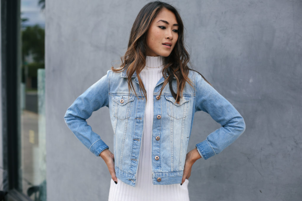 woman in white dress and denim jacket
