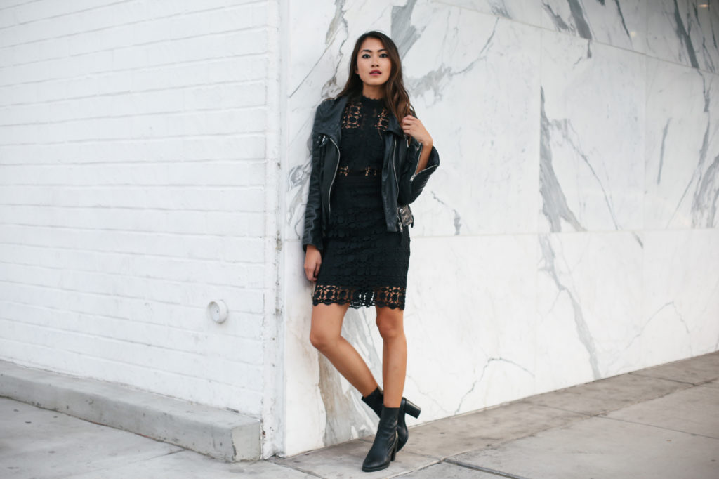 woman wearing black lace dress and leather jacket