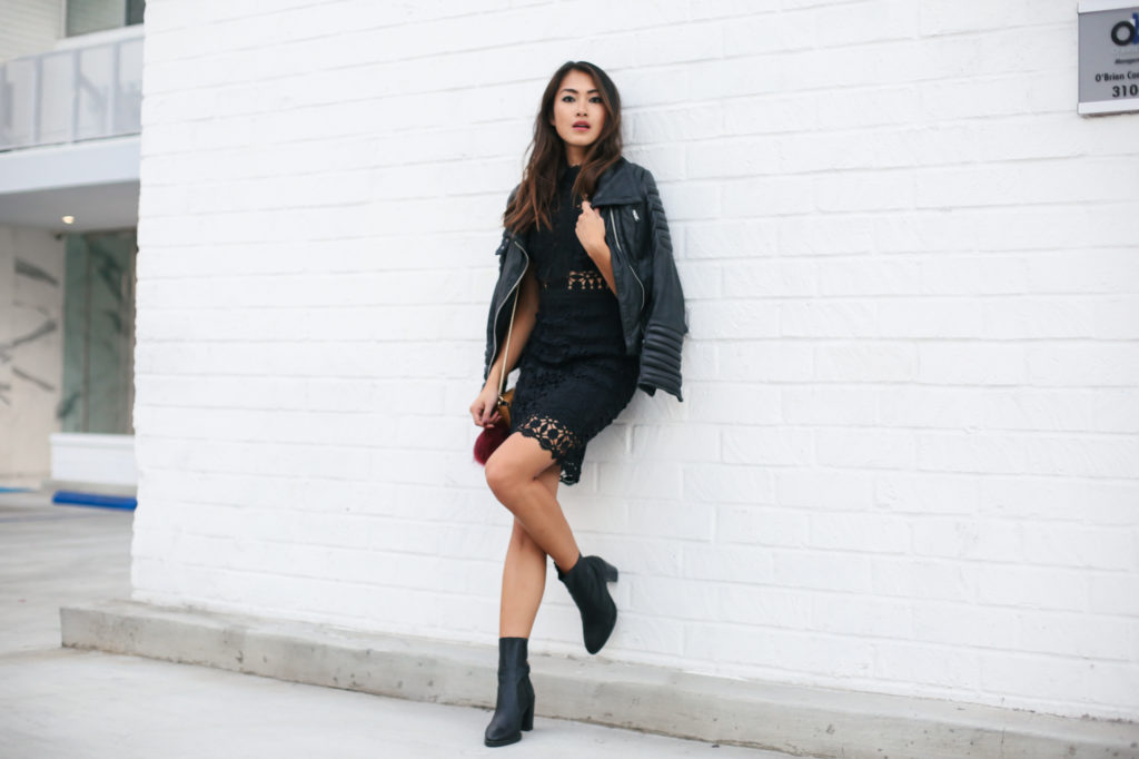 woman wearing black dress and leather jacket