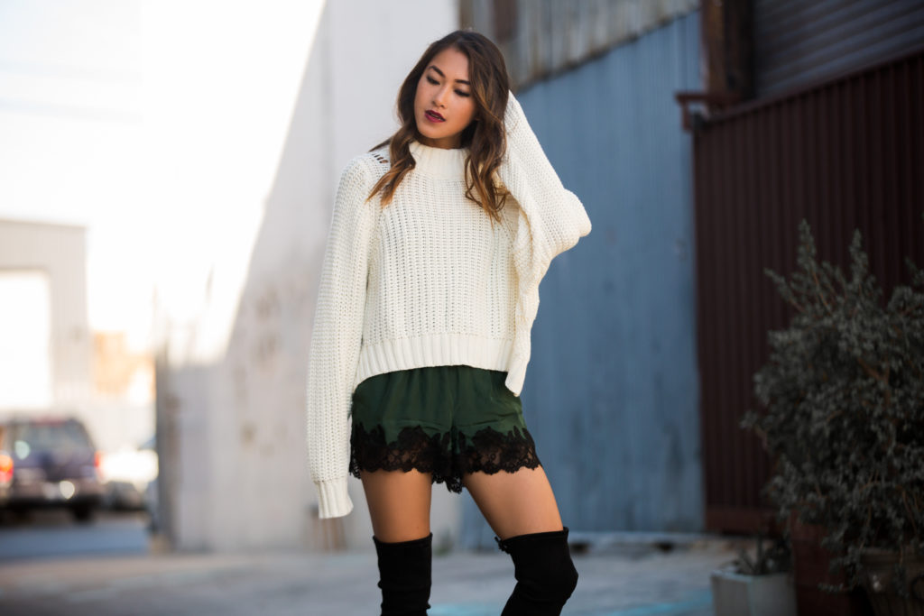 woman wearing sweater and shorts