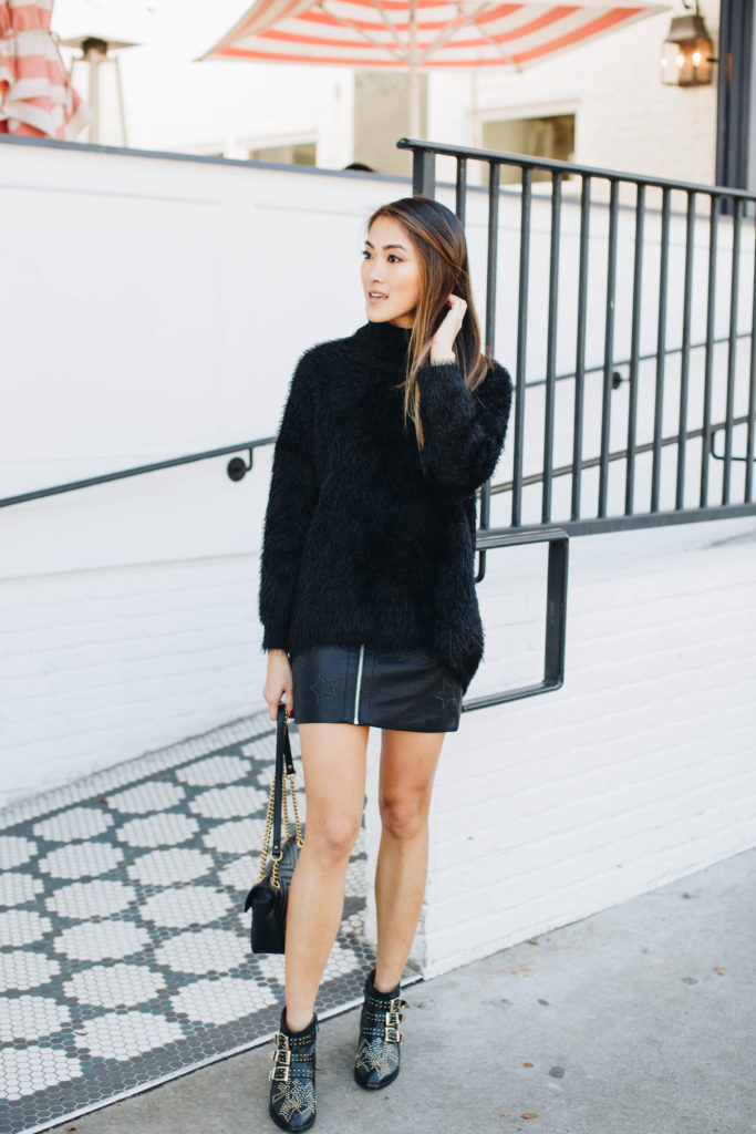 woman wearing black sweater and skirt and sharing the Pros and Cons of "Fake it Till You Make it" 