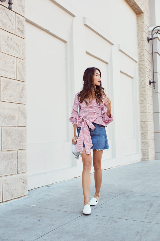woman wearing striped statement top and denim skirt