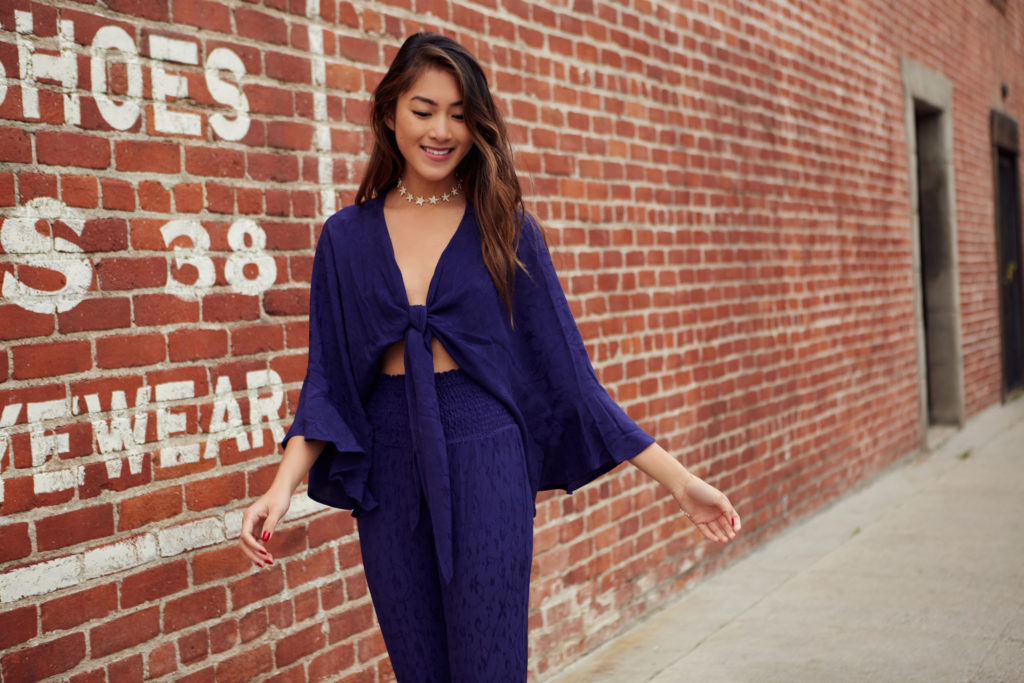 woman on slowing down and wearing violet top and pants