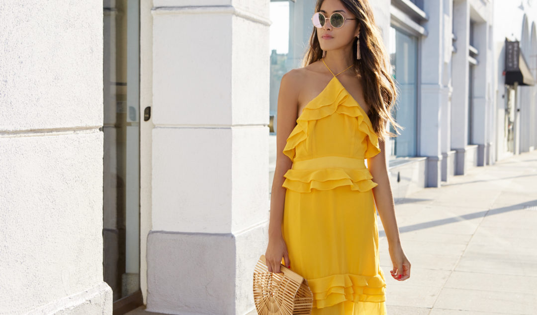 Amy is wearing a gorgeous yellow halter top ruffle dress.
